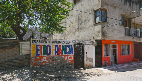 Weathered Petro and Francia campaign wall in Taganga, Colombia